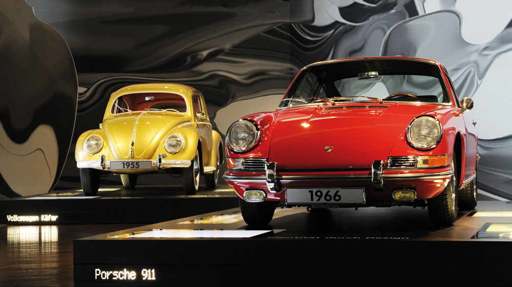 A VW Beetle (L) from 1955 and a Porsche 911 built in 1966 - PH: Press Association